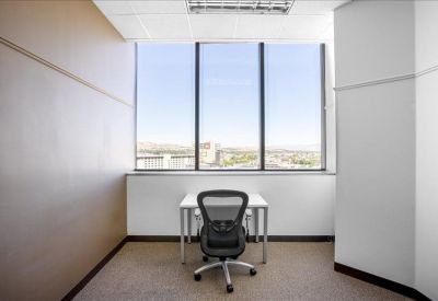 Single workstation in a private office with large windows.