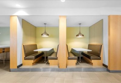 Two private dining or work booths with wood paneling and pendant lighting.