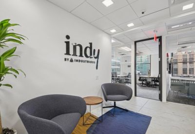 Reception area featuring modern armchairs and branded wall signage.