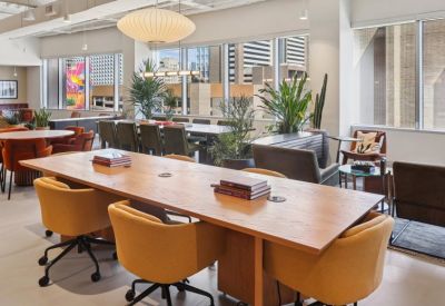 Bright coworking area with colorful seating, wooden tables, and large windows.