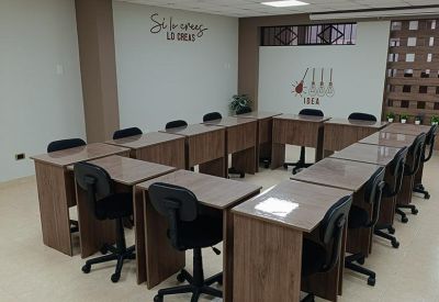 Classroom style training room with wooden desks arranged in a U-shape.
