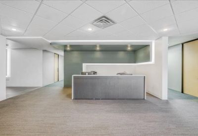 Clean, minimalist reception desk with integrated ceiling lighting.