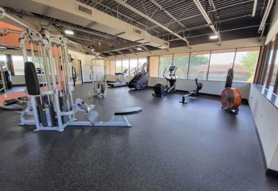 On-site fitness center equipped with weight machines, ellipticals, and rowing machines.