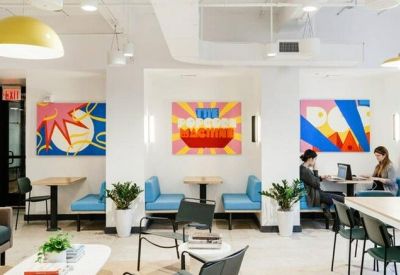 Coworking area featuring colorful pop-art murals and teal booth seating.