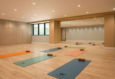 Spacious yoga room with mats and natural light.