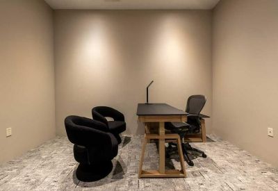 Coworking area featuring acoustic phone booths for private calls and comfortable seating.