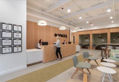 Bright reception area featuring a wooden front desk and comfortable seating.