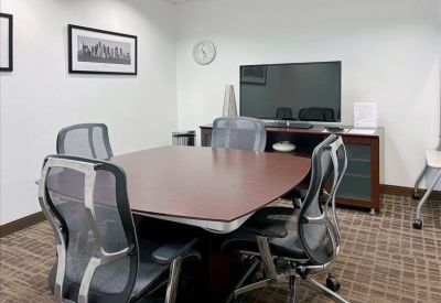 Modern reception desk with a white center and colorful geometric wall art.