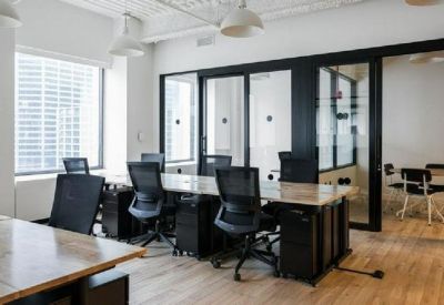 Professional open-plan office with multiple workstations and glass-walled meeting rooms.