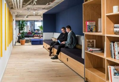 Modern hallway featuring a long wooden bench seat and built-in bookshelf.