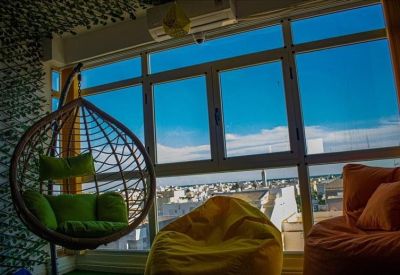 Spacious corner office with multiple desks and panoramic window views.