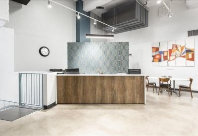 Reception area with a wood-paneled front desk and small seating area.