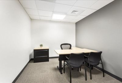 Private two-person office suite with a dark wood filing cabinet.