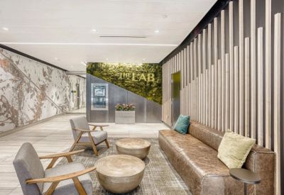 Modern lobby with a moss feature wall, leather sofa, and 'The Lab' branding.