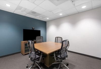 Modern reception area with a wood-fronted desk and professional staff.