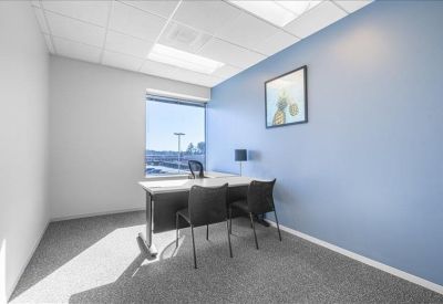 Private office suite with a blue accent wall and large window.