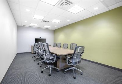 Bright reception area featuring a wood-panelled front desk and red wall accents.