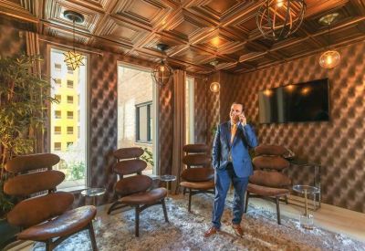 Stylish lounge with wood-paneled ceiling and unique modern armchairs.