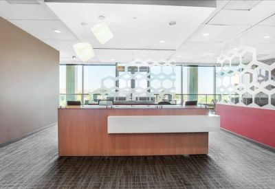 Reception desk area with a wooden counter and decorative honeycomb screen.