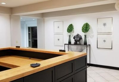 Bright reception desk with warm wood accents and modern art decor.