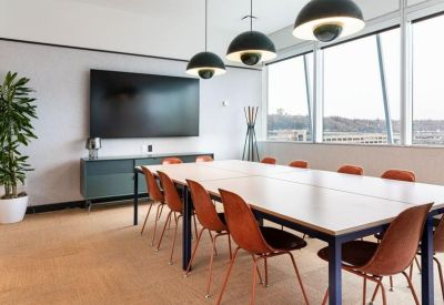 Professional conference room with a large screen and leather chairs.