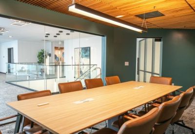 Modern meeting room at 2551 San Ramon Valley Boulevard, California with a long wooden table and leather chairs.