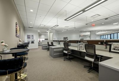 Open-plan workspace with multiple desks and modern lighting.