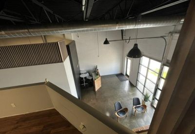 High-angle view of a bright reception area with glass doors and polished concrete floors.