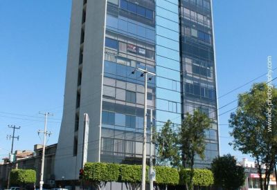 Modern meeting room with city views and sleek furniture.
