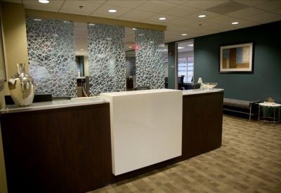 Professional reception area featuring a sleek dark wood and white front desk.