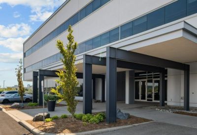 Entrance path with handicap accessible sign and glass doors.