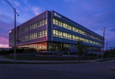 Building exterior at dusk with illuminated windows.