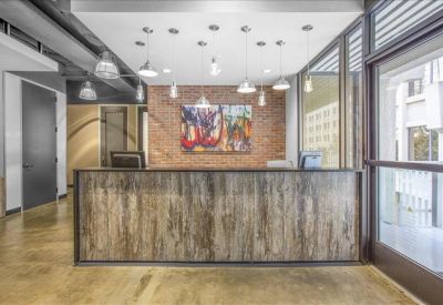 Reception area featuring a wood-panelled front desk and modern pendant lighting.