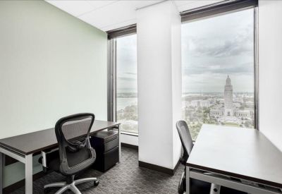 Bright two-person office with floor-to-ceiling windows and city views.