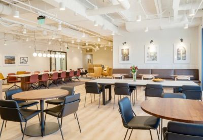 Spacious communal lounge and dining area with modern furniture and warm lighting.