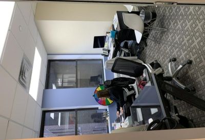 Private office suite featuring a desk, office chair, and geometric patterned carpet.