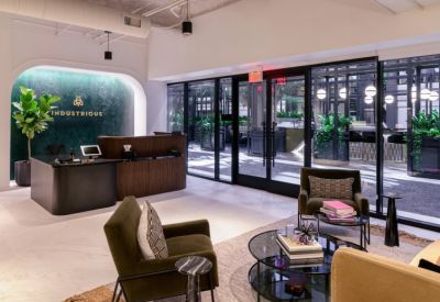Modern reception area with a dark wood desk and green marble feature wall.