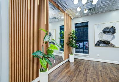 Modern interior corridor with a wood slat feature wall and a full-length mirror.