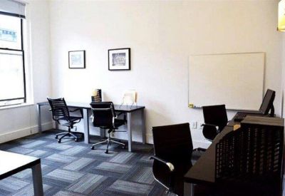 Private office space with two desks, ergonomic chairs, and a whiteboard.