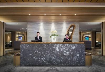 Private office at Spaces Newbury Street with white desk, orchid plants, and large window.