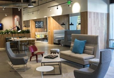 Modern lounge area with stylish armchairs, a coffee table with a board game, and high-back seating.