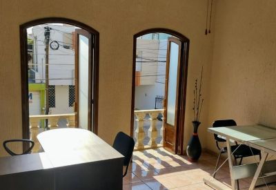 Bright office space with arched balcony doors and natural light.