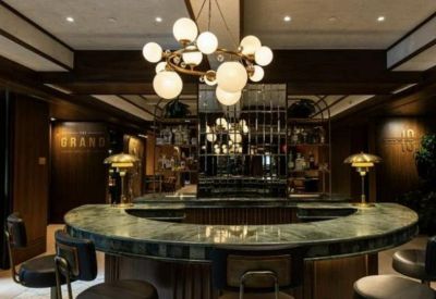 Stylish lounge and bar area with a marble counter and modern globe chandelier.