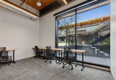 Shared workspace featuring sleek black chairs and a window view.