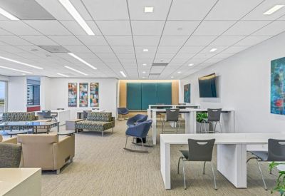 Open-plan coworking space with various seating options and modern art.