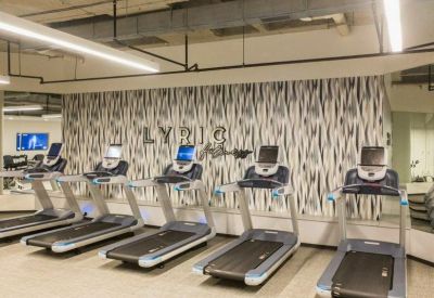 On-site fitness center with a row of modern treadmills.
