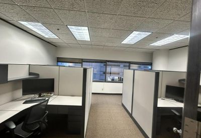 Office cubicles with desks, chairs, and monitors.