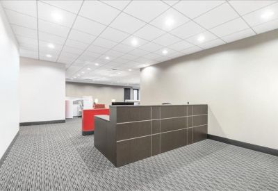 Professional reception area with a dark wood front desk.