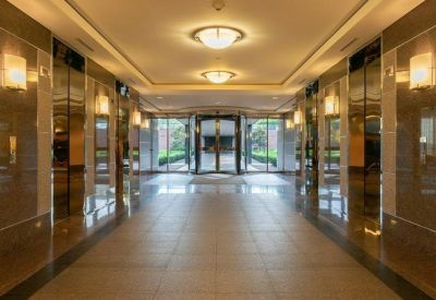 Upscale elevator lobby with marble-style walls and warm ceiling lighting.