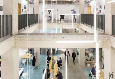 Multi-level open-concept workspace with a mezzanine balcony and natural light.